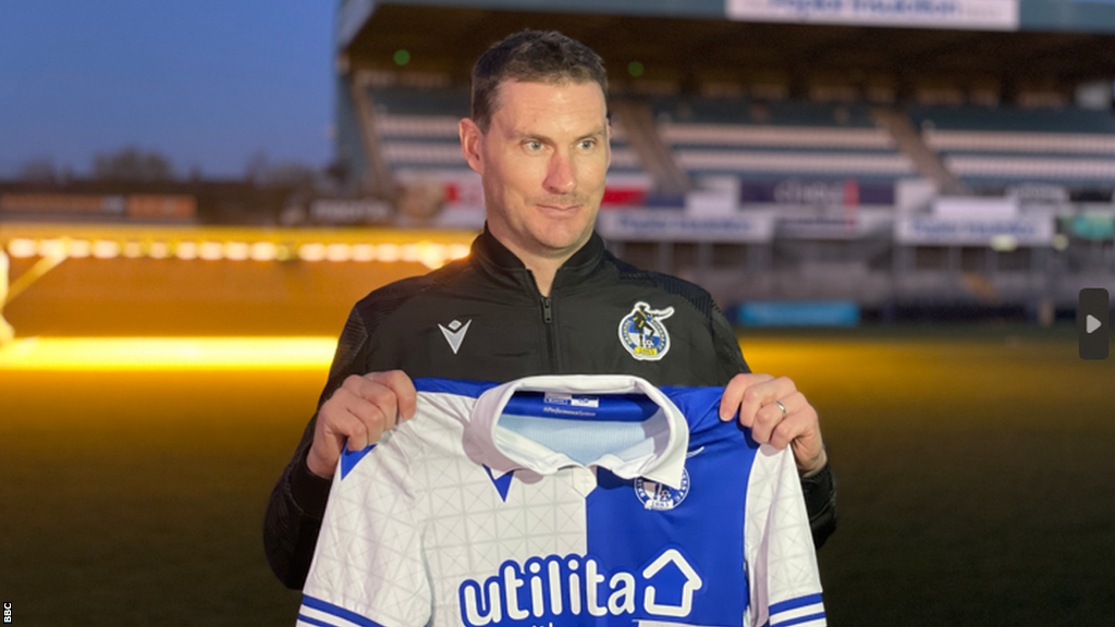 Matt Taylor holds a Bristol Rovers shirt