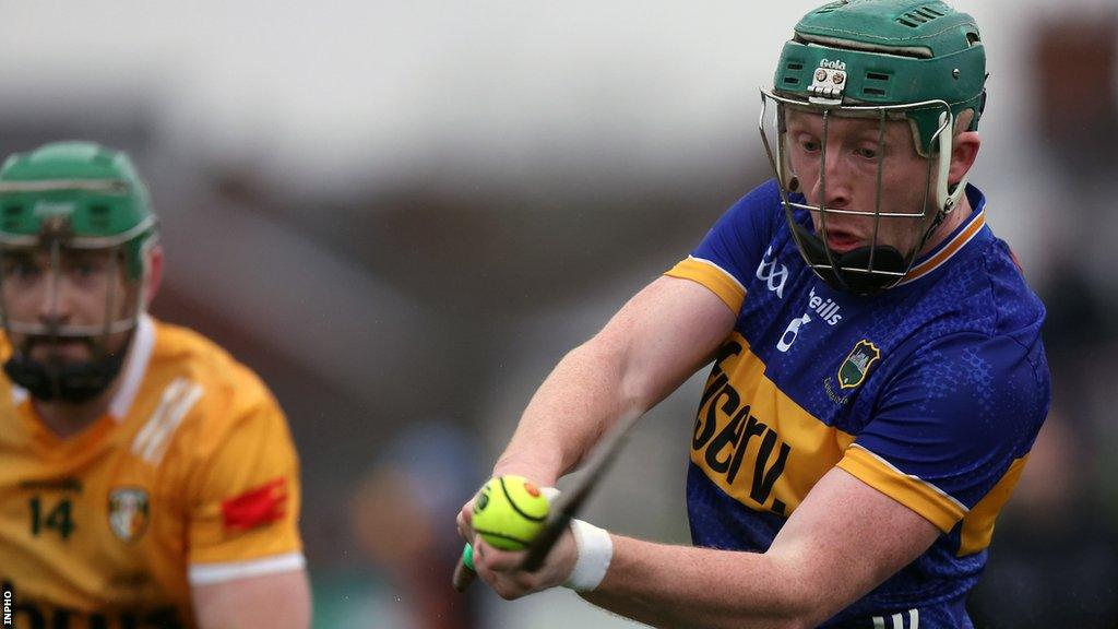 Tipperary's Robert Byrne makes a clearance despite Conor McCann's efforts at Corrigan Park