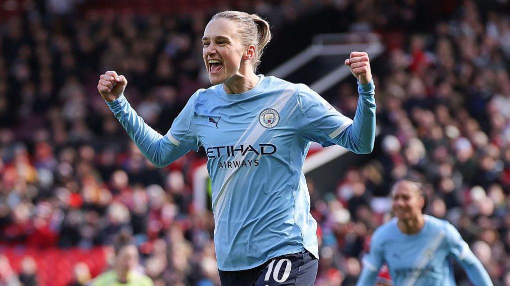 Vivianne Miedema celebrating on the pitch in Man City's light blue kit
