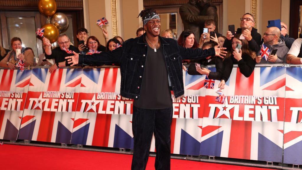 KSI in front of a BGT banner with arms outstretched