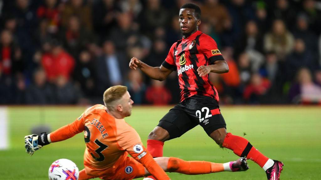 Junior Traore of Bournemouth shoots past Jason Steele of Brighton