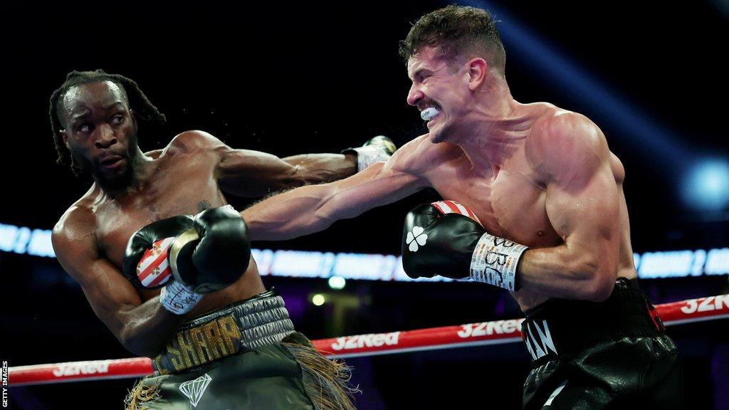 Nathan Heaney (right) throws a punch during his British middleweight title fight against Denzel Bentley