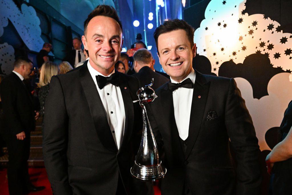 Ant & Dec stand next to eachother and smile at the camera