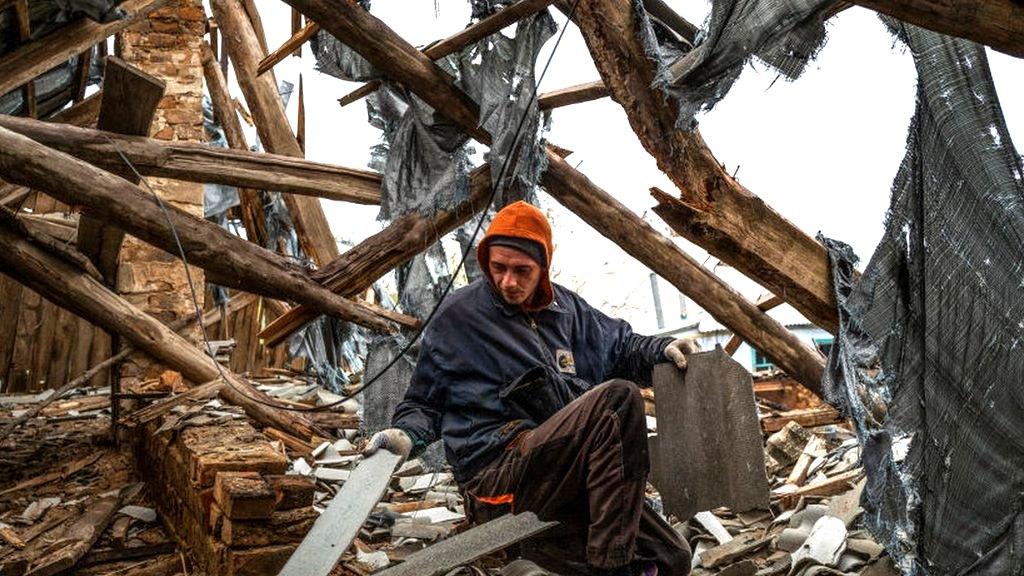 Person going through rubble in demolished building in Kherson region