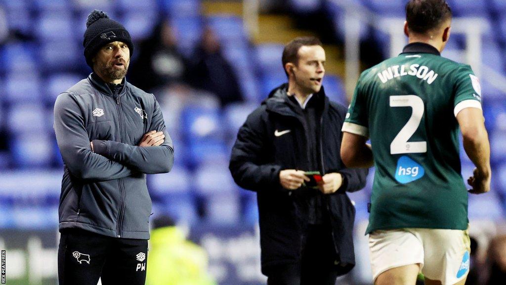 Paul Warne watches his Derby team from the side of the pitch