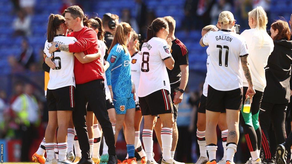 Manchester United boss Marc Skinner embraces his players after the final whistle