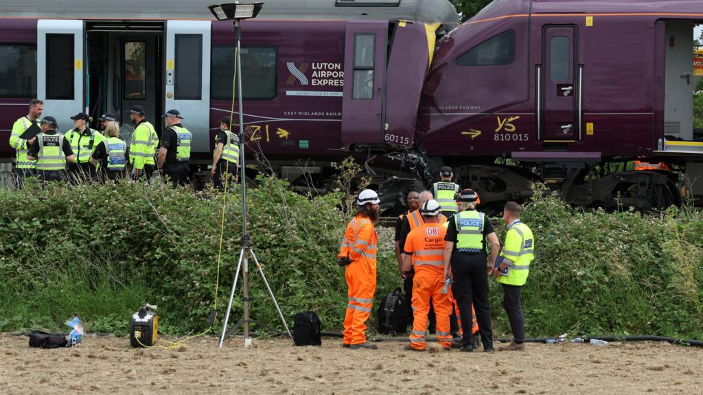 Police officers outside the trains that crashed near Bedford