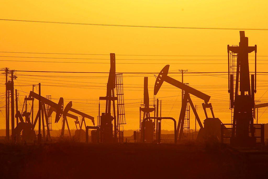 Pump jacks are seen at dawn in an oil field over the Monterey Shale formation where gas and oil extraction using hydraulic fracturing, or fracking, is on the verge of a boom on March 24, 2014 near Lost Hills, California.