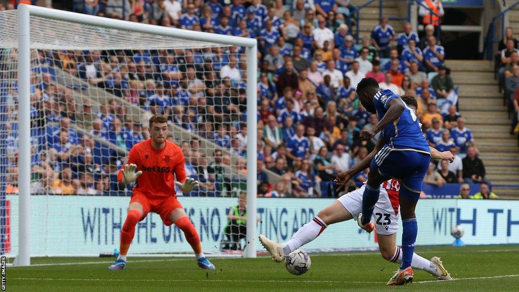 Leicester City's Kelechi Iheanacho shoots past Stoke City's goalkeeper Mark Travers