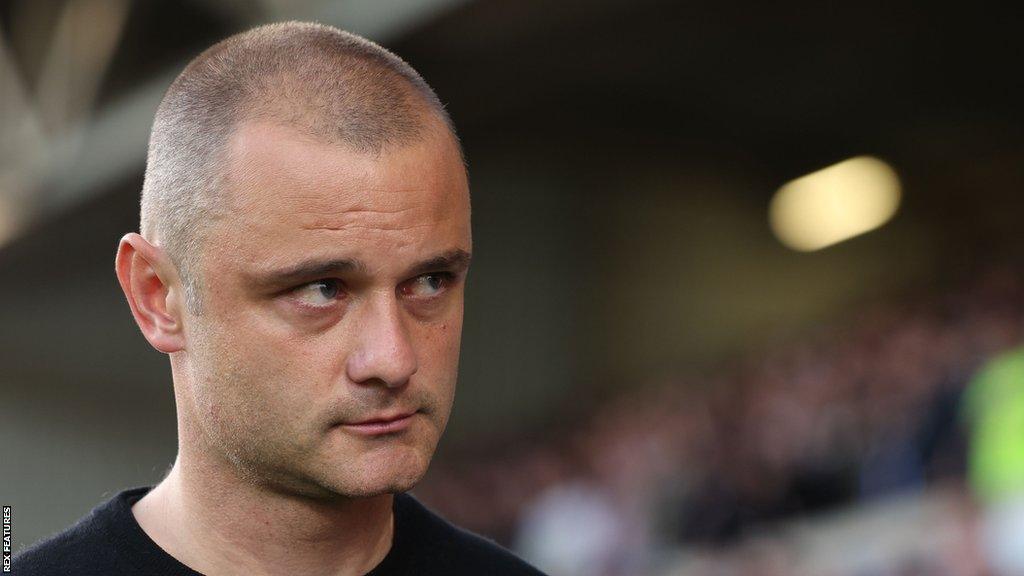 Wigan Athletic manager Shaun Maloney looks on