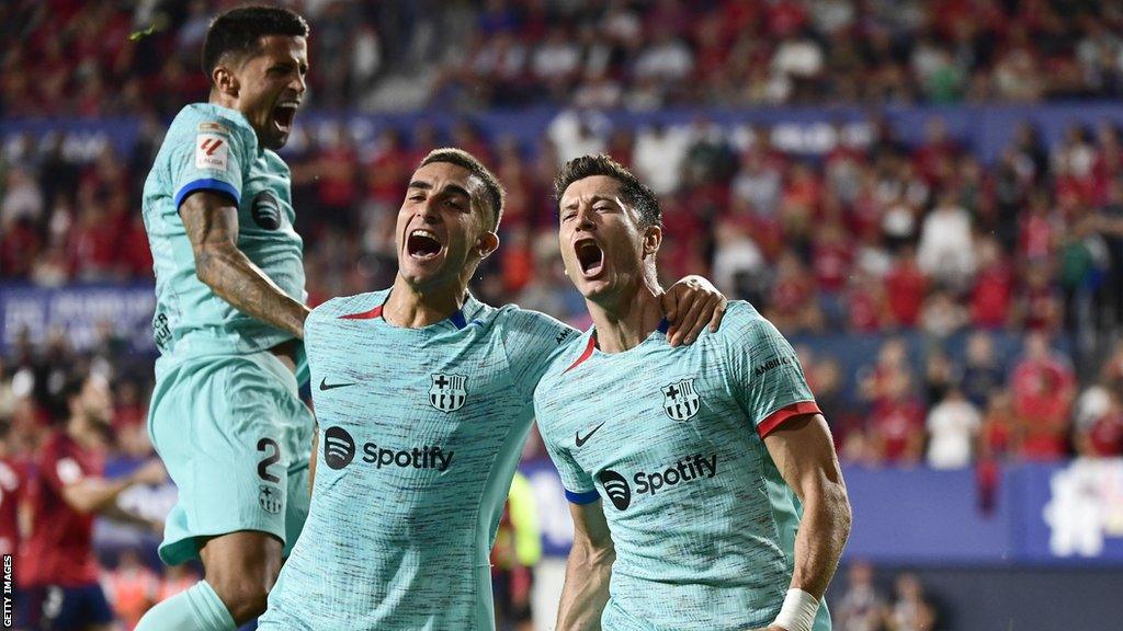 Joao Cancelo, Ferran Torres and Robert Lewandowski celebrate