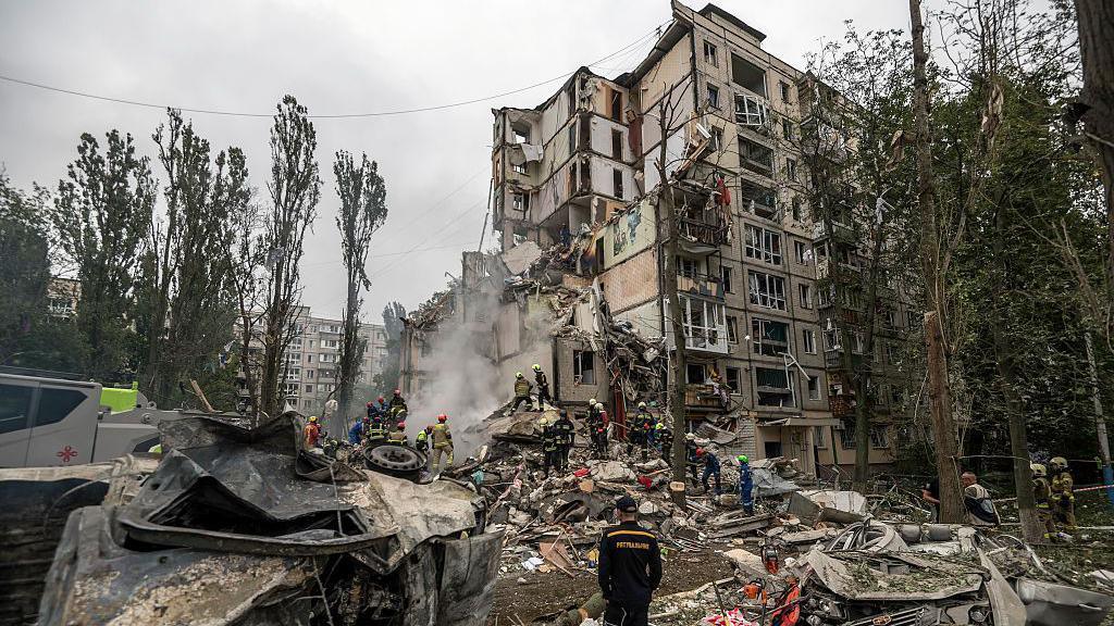 Rescuers work at the site of a residential building destroyed by a direct hit from a Russian cruise missile during missile and drone strikes amid Russia's ongoing attack on Ukraine, in Kyiv, Ukraine, on July 31, 2025