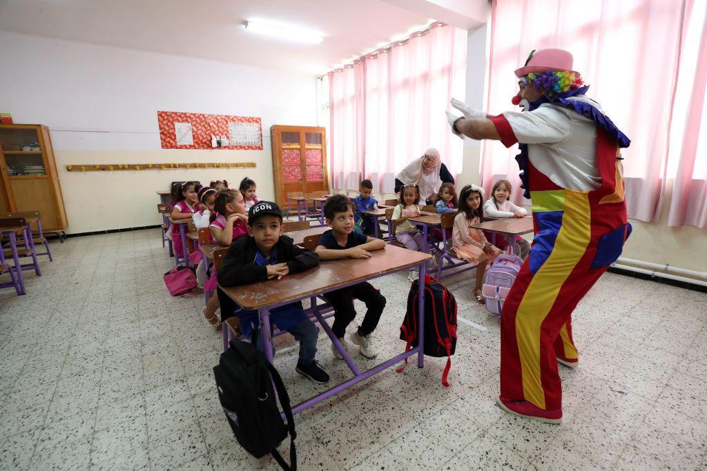 A clown performs in front of pupils in a classroom in Algeria September 22, 2024