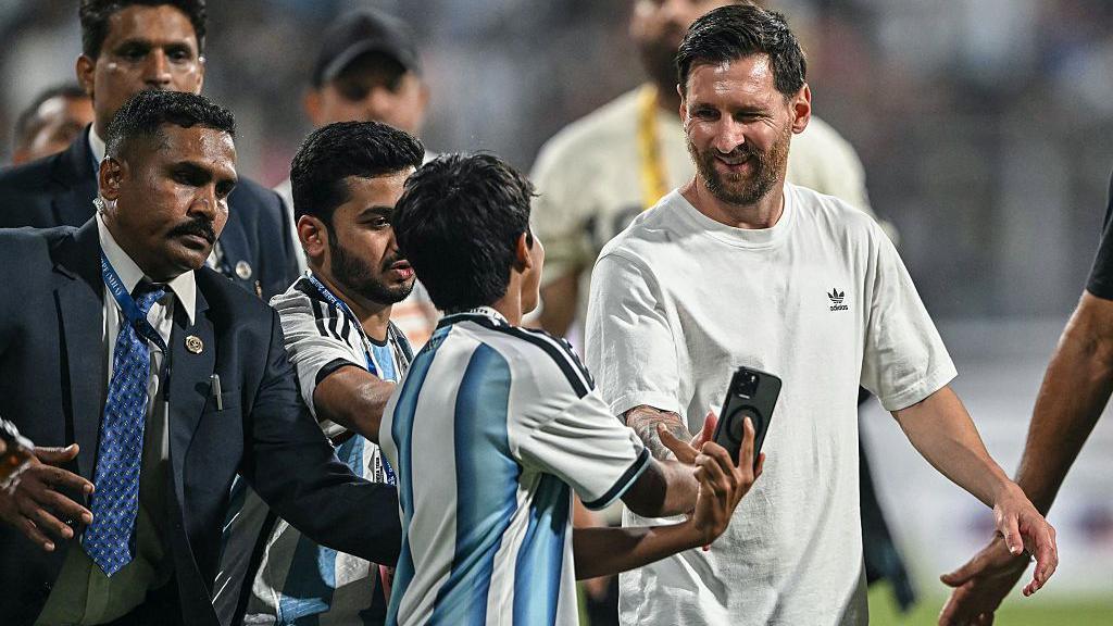 Lionel Messi meets with a young fan during his GOAT Tour at the Wankhede Stadium in Mumbai