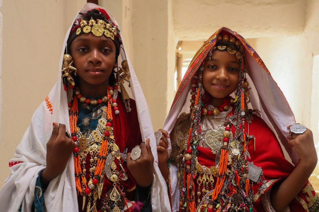 Girls dressed in traditional attire pose for a picture during the Ghadames Festival celebrating the cultural and artistic heritage of the Libyan city.