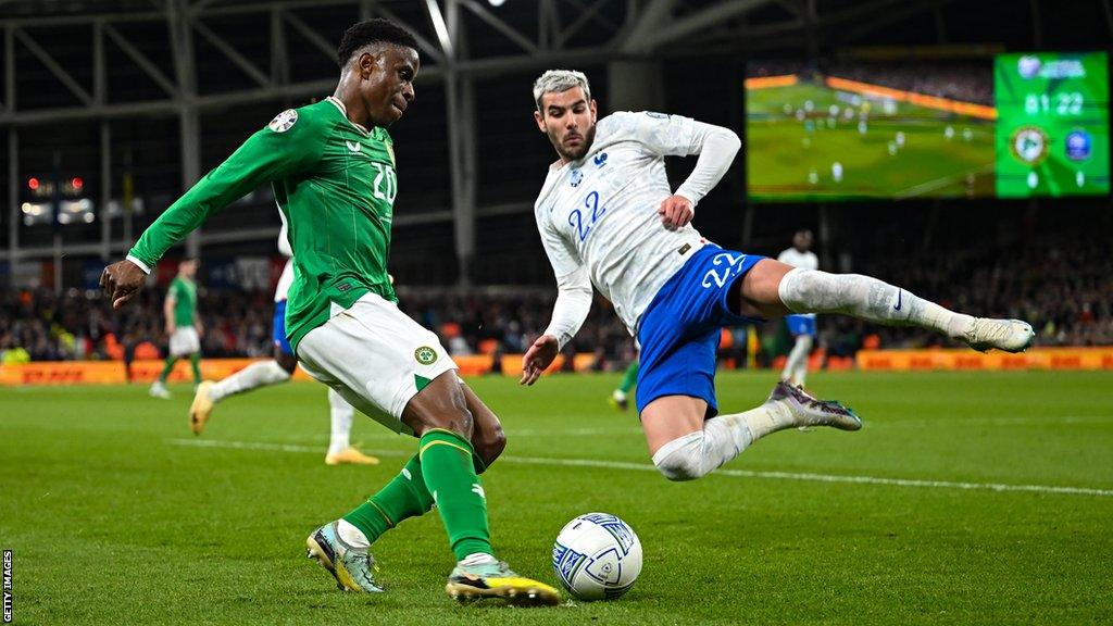 Chiedozie Ogbene and Theo Hernandez in action