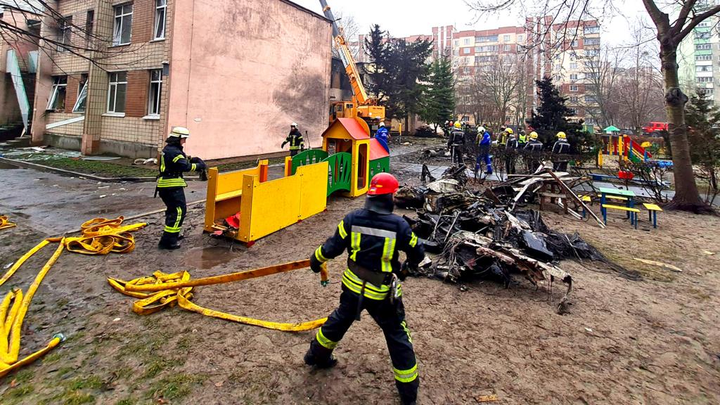 Rescue services work at the scene of a helicopter crash in Brovary, near Kyiv, Ukraine, 18 January 2023
