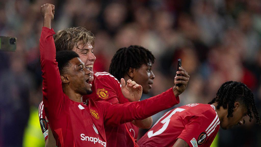 Amad Diallo and Rasmus Hojlund celebrate Hojlund's goal by taking a selfie.