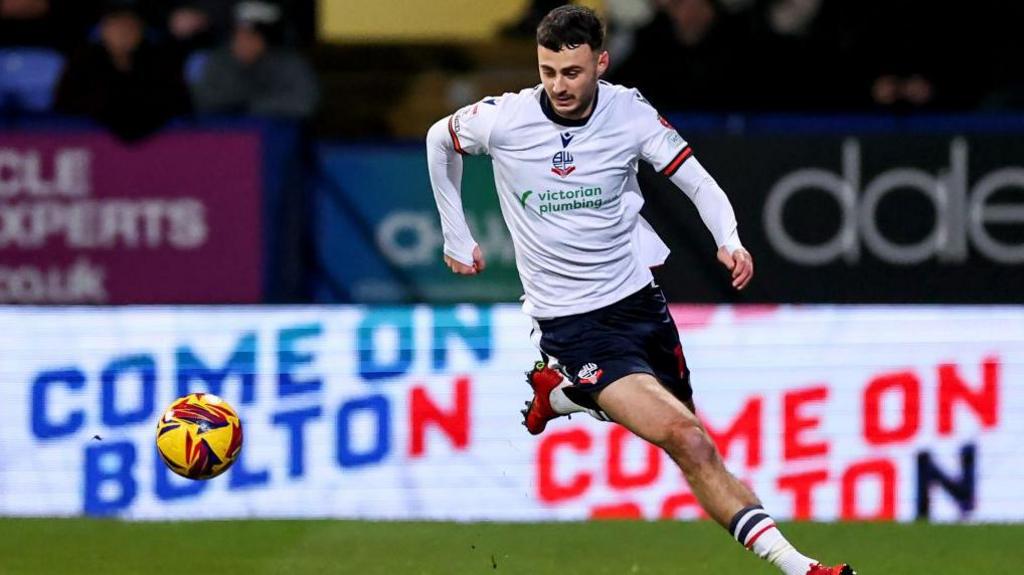 Aaron Collins chases the ball for Bolton