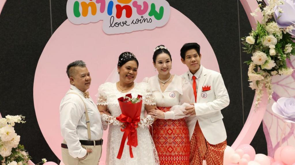 Couples pose for photographs during an event to mark the country's same-sex marriage law coming into effect in Bangkok