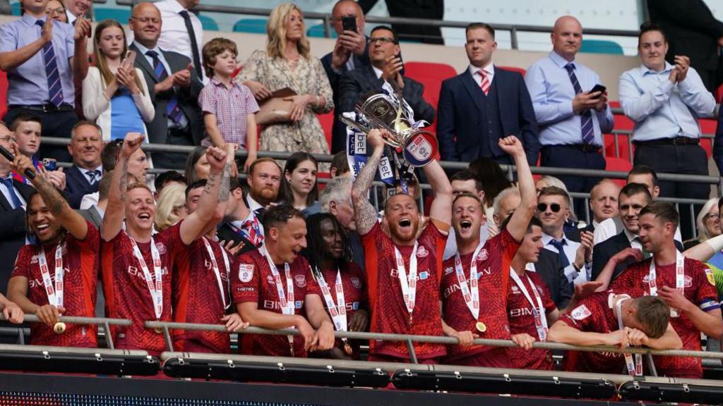 Carlisle lift the League Two play-off final trophy at Wembley