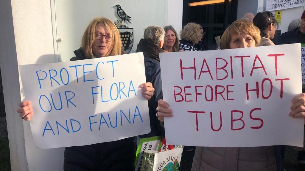 Campaigners holding placards