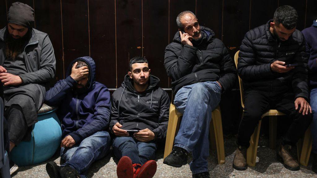 Palestinian families react after Israel delayed the release of Palestinian prisoners, scheduled to be released in the seventh hostage-prisoner exchange, in the occupied West Bank city of Ramallah early on February 23, 2025.