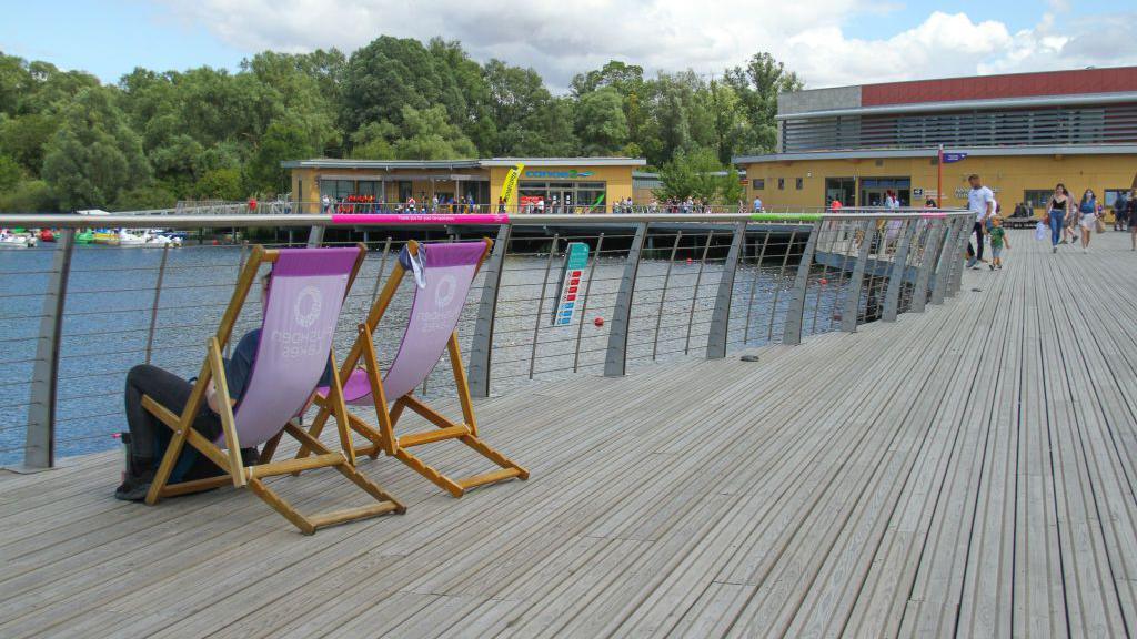 Two chairs on a jetty at Rushden Lakes