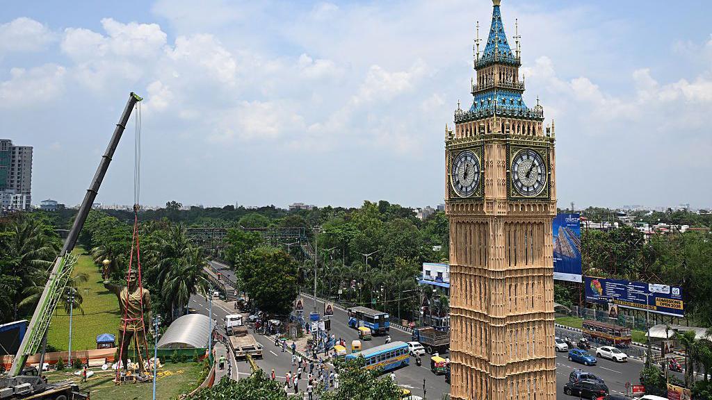 A general view of the area which shows a crane attached to Lionel Messi's statue and a version of Big Ben to the right of the picture.