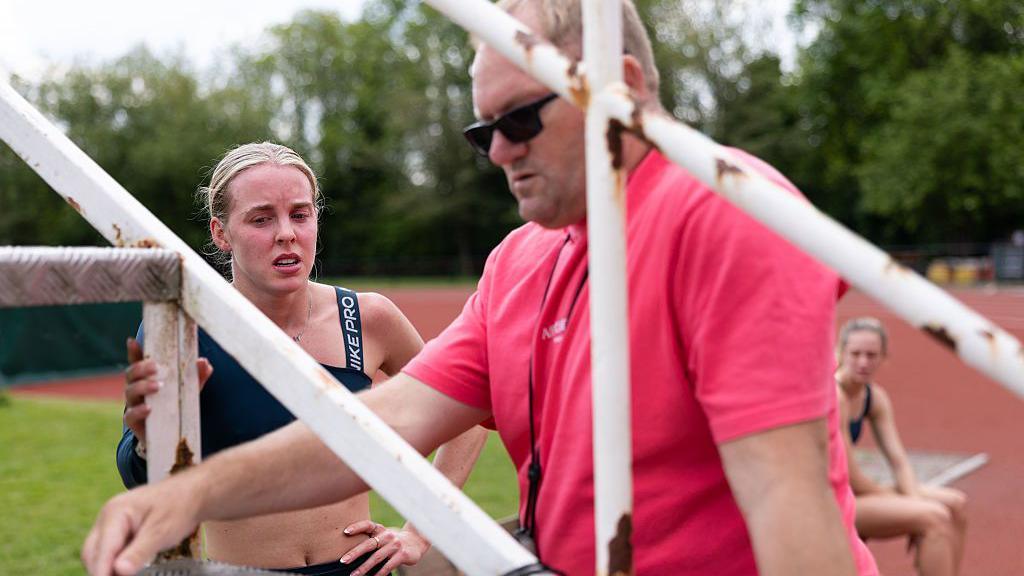 Keely Hodgkinson listens to coach Trevor Painter during a track session