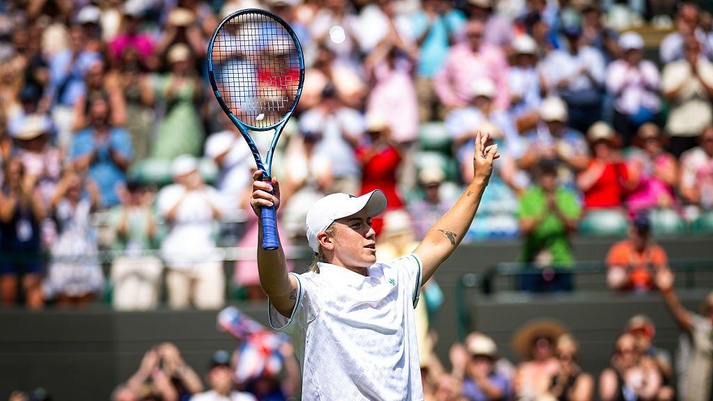 Sonay Kartal raises her arms aloft astatine Wimbledon