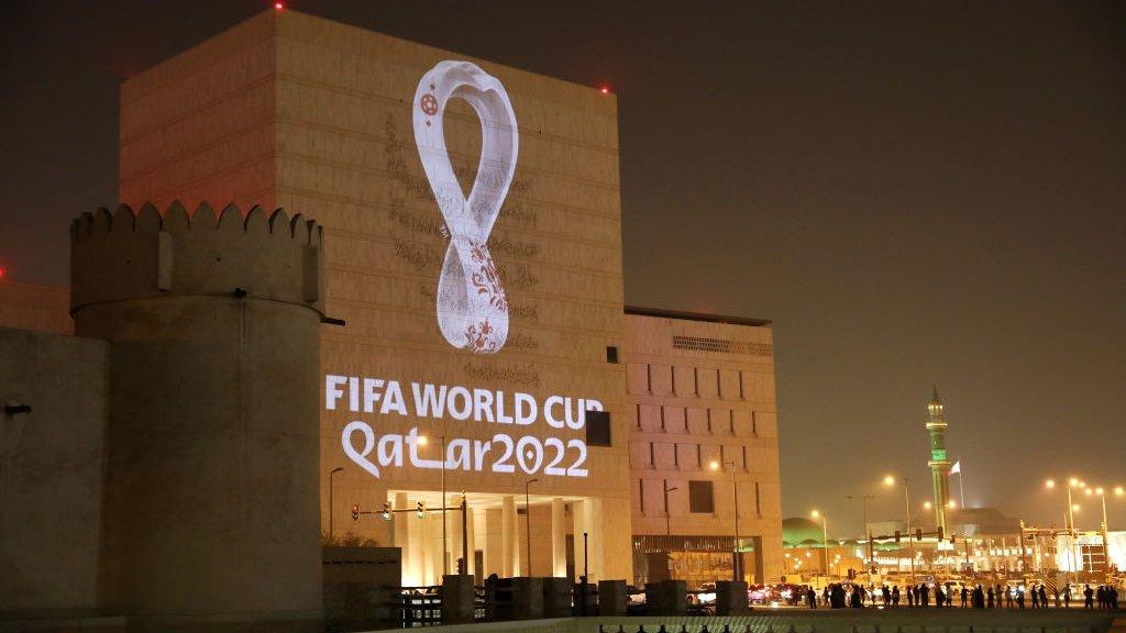 The 2022 World Cup logo projected onto a building in Qatar