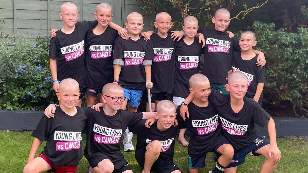 Group photo of the boys after they shaved their heads