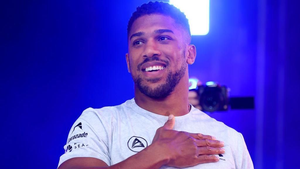 Anthony Joshua holds his hand to his chest