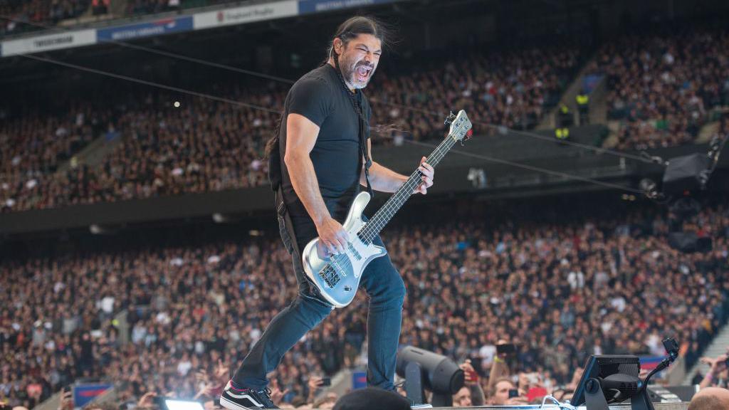 Robert Trujillo of Metallica performs on stage to a crowd at Twickenham Stadium on 20 June 2019.