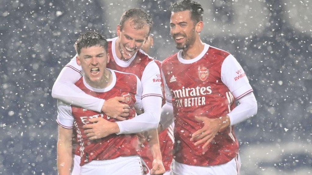 Kieran Tierney celebrates in the snow