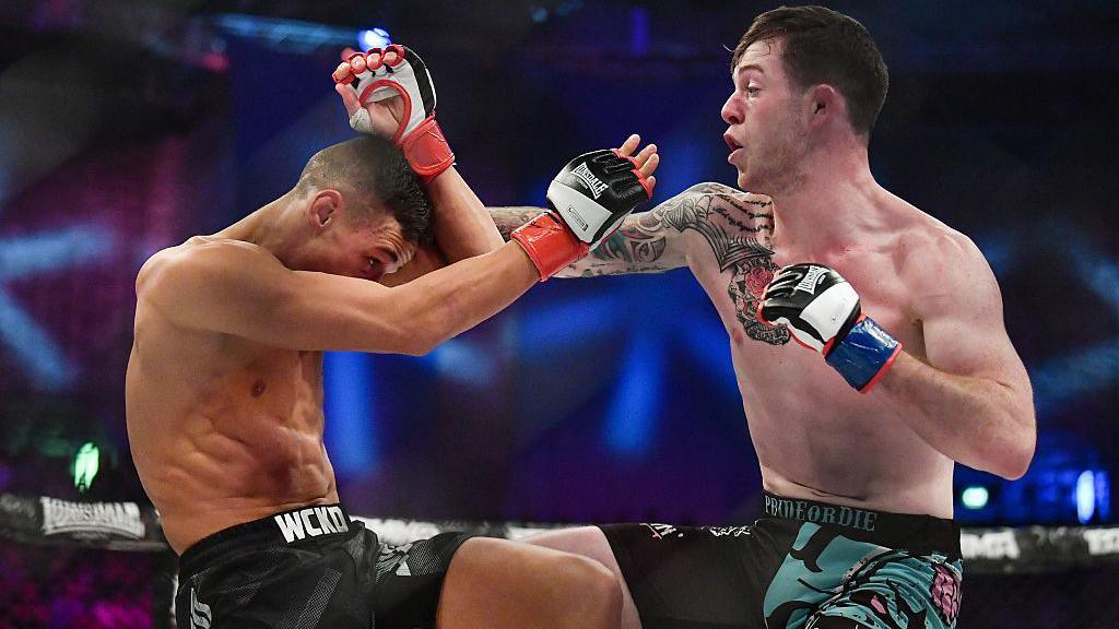 Tom Duquesnoy in action against Alan Philpott during their BAMMA World Bantamweight Title bout 