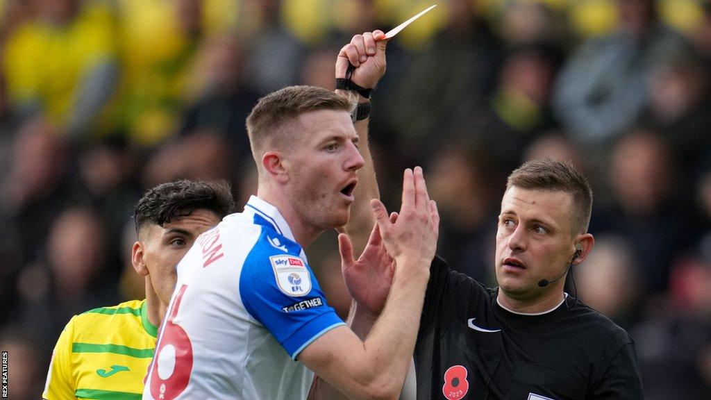 Blackburn's Scott Wharton is shown a red card by referee Josh Smith