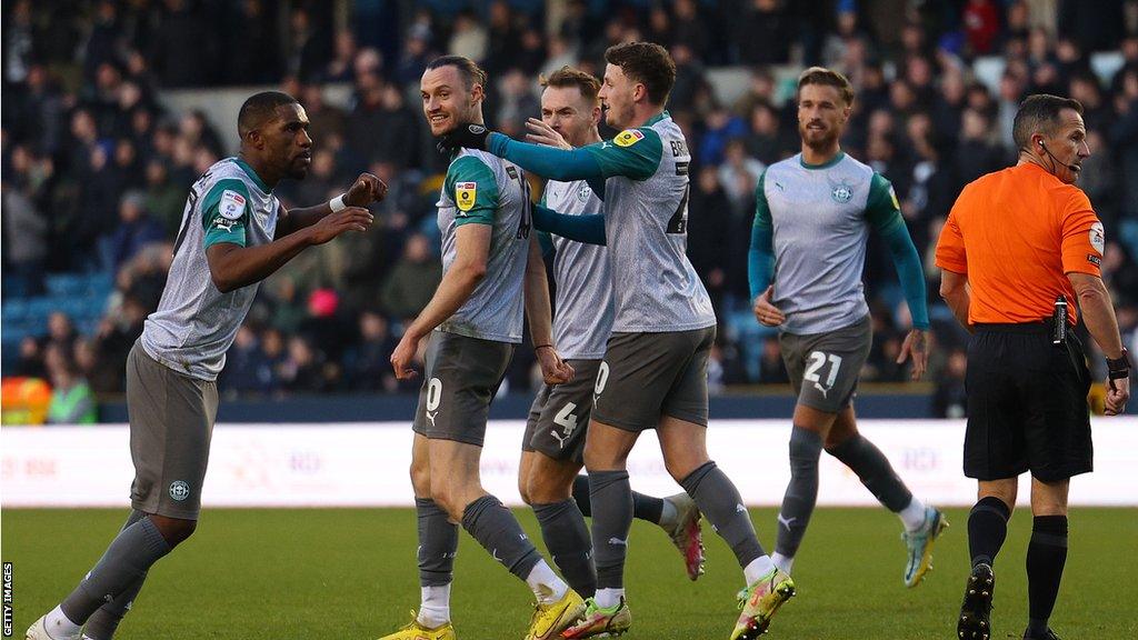 Wigan celebrate Will Keane's goal against Millwall