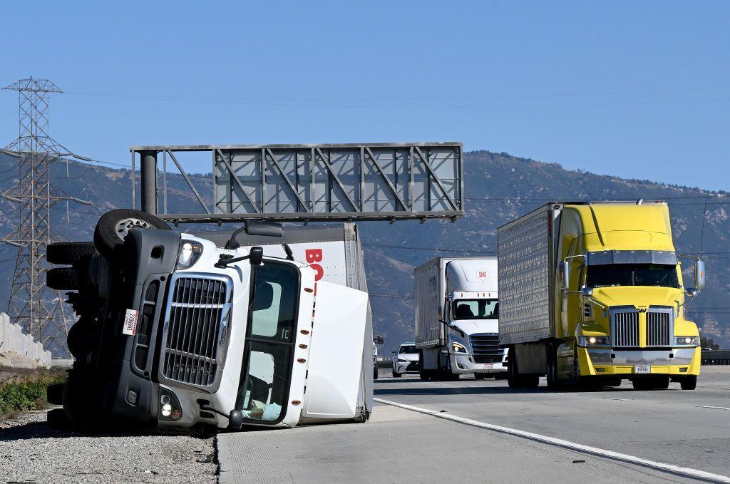 A large truck sits blown over on its side after being toppled by high Santa Ana Winds.