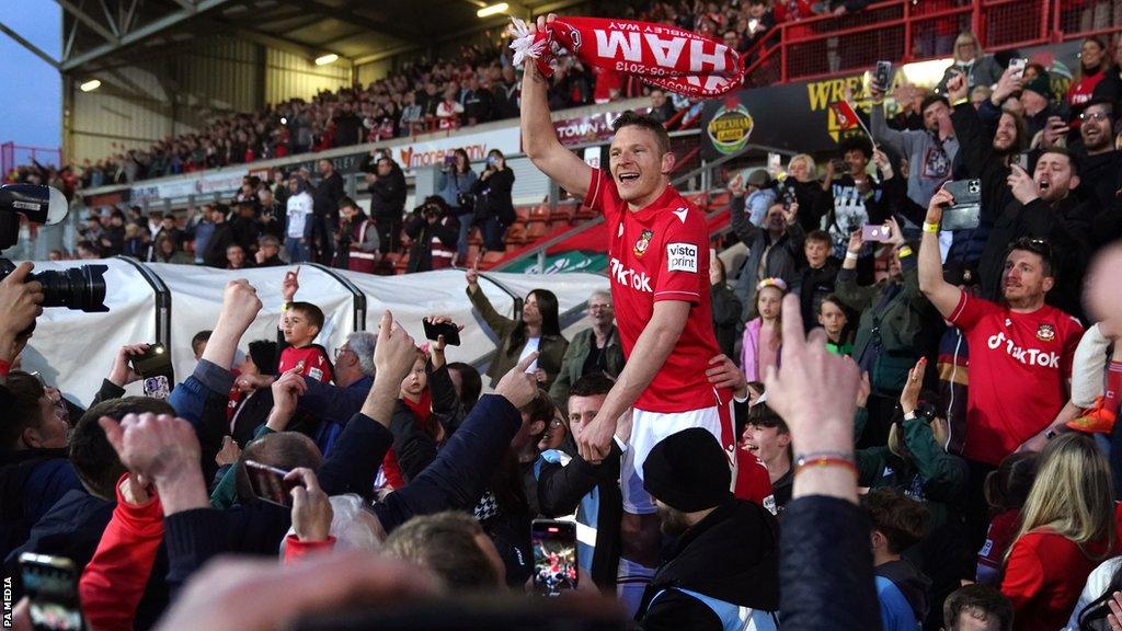 Wrexham goal hero Paul Mullin celebrates with fans after sealing the National League title and promotion