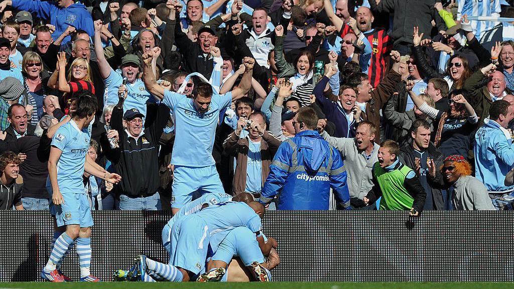 Manchester City players celebrate Sergio Aguero's goal against QPR