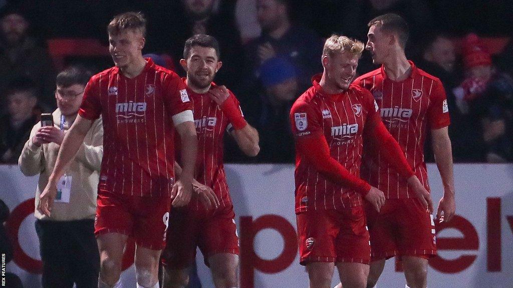 Cheltenham players celebrate a goal against Oxford