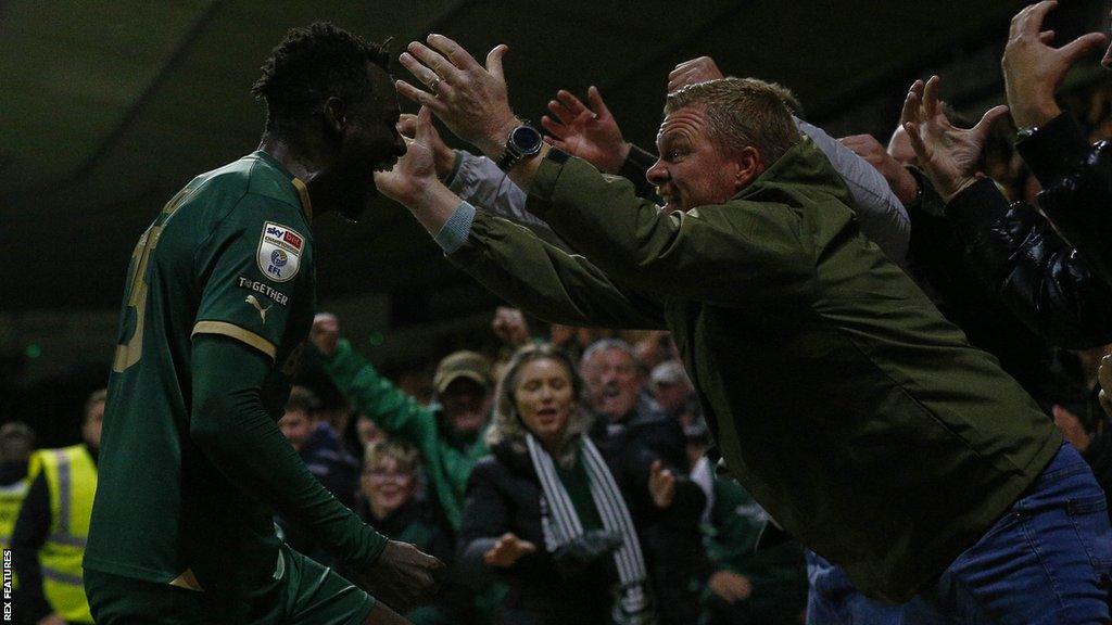 Mustapha Bundu celebrates scoring for Plymouth Argyle