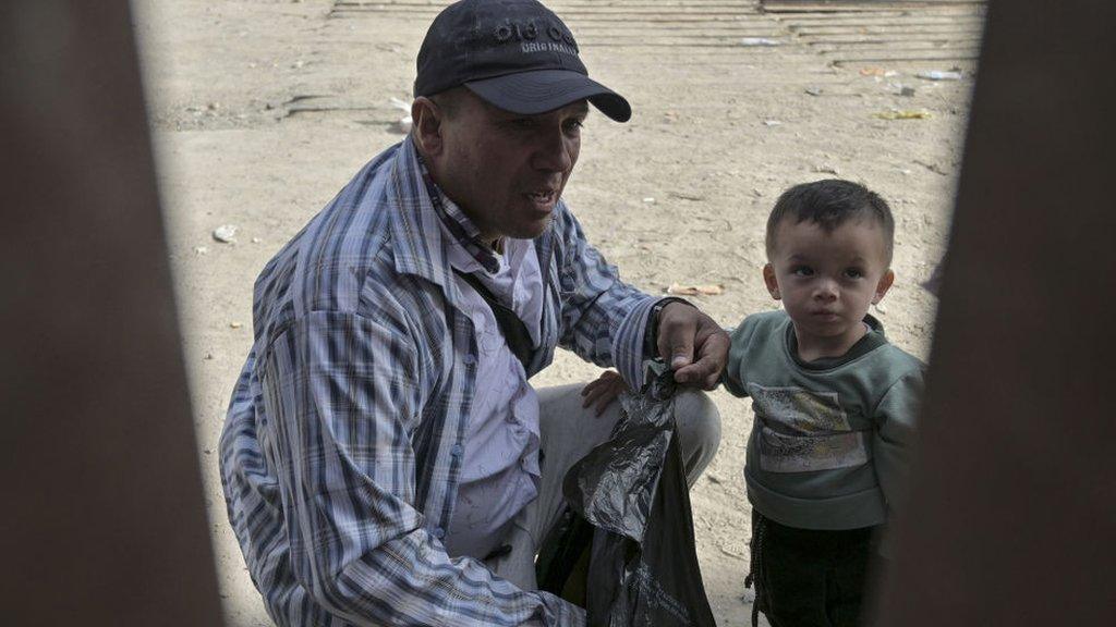 Migrant with child at the Texas-Mexico border