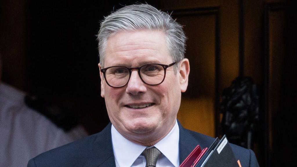 Sir Keir Starmer leaves Downing Street wearing a suit and holding two folders