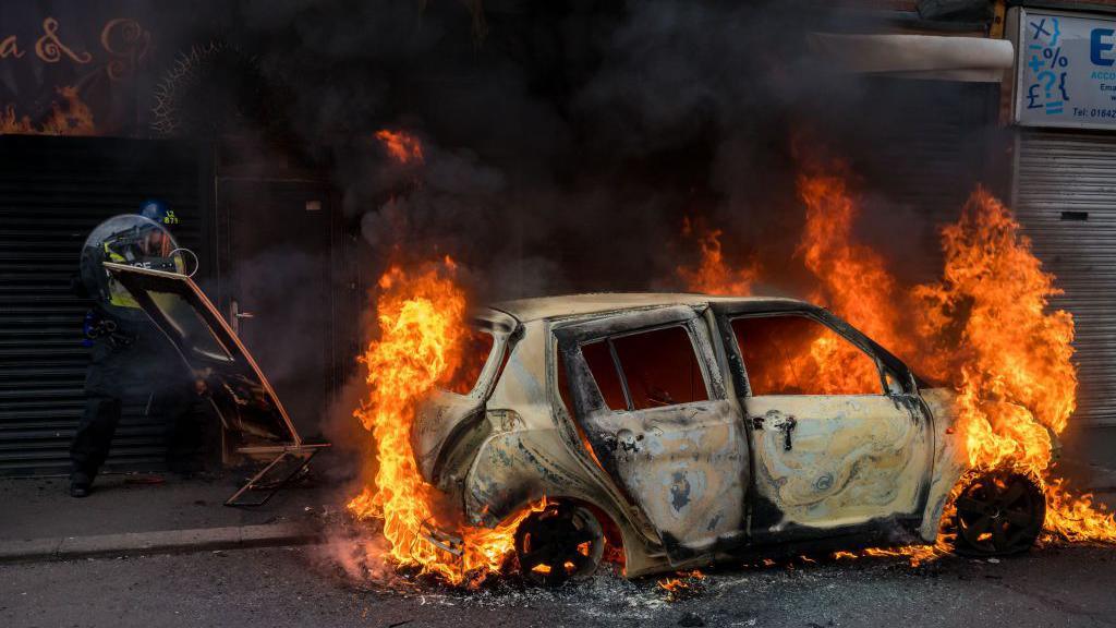 A car burns in Parliament Road