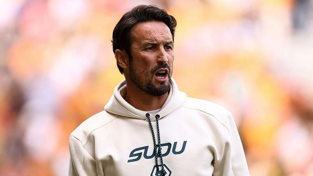 Wolves head coach Cesar Peixoto in cream hooded top shouts instructions to his team during their 3-0 friendly win over Racing Santander
