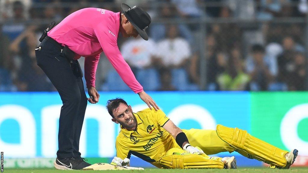 Australia's Glenn Maxwell holds his right calf during his double century innings against Afghanistan at the Cricket World Cup