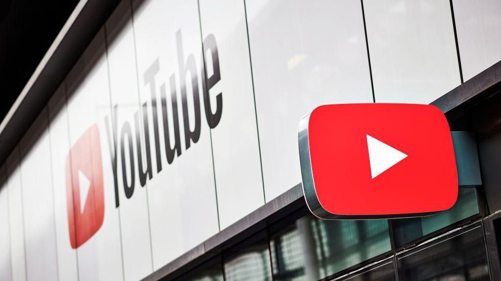 The YouTube brand on the side of a building, with a sign in the shape of the YouTube logo jutting out from the same building